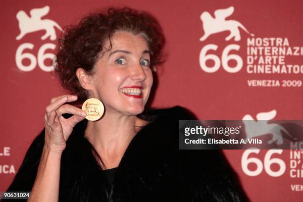 Production Designer Sylvie Olive holds the Osella award she received for best production designer attends the Closing Ceremony photocall at the...