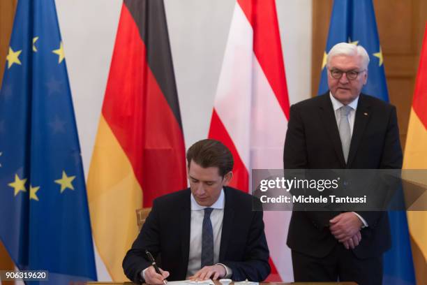 Austrian Chancellor Sebastian Kurz signs the Guestbook as German federal President Frank-Walter Steinmeier stands in the Bellevue Castle on January...