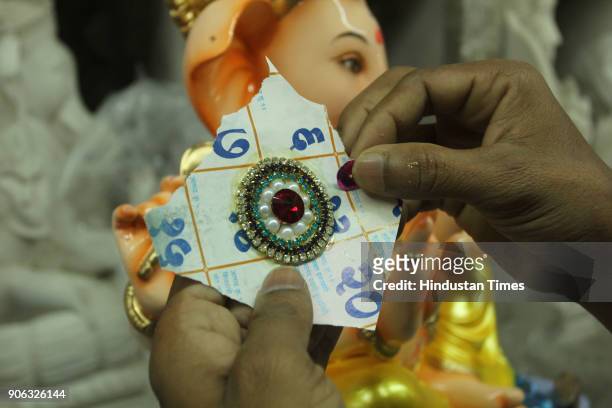 An artist making idols of Ganesh for the upcoming Maghi Ganesh Chaturthi festival, at Thane workshop, on January 17, 2018 in Mumbai, India.