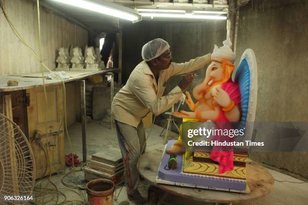 An artist making idols of Ganesh for the upcoming Maghi Ganesh Chaturthi festival, at Thane workshop, on January 17, 2018 in Mumbai, India.