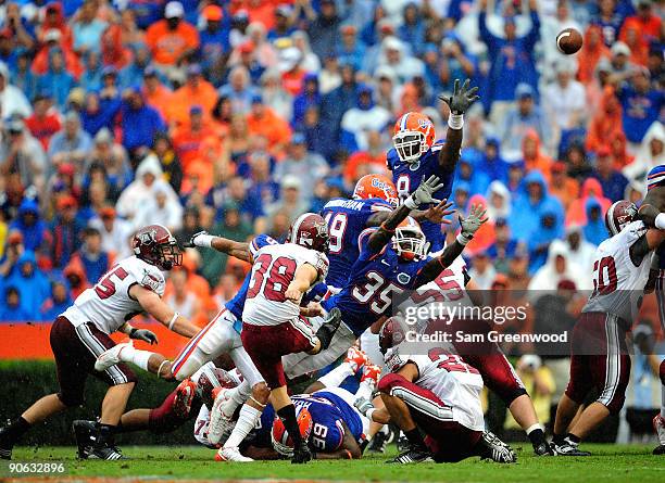Ahmad Black of the Florida Gators attempts to block a kick by Sam Glusman of the Troy Trojans during the game at Ben Hill Griffin Stadium on...