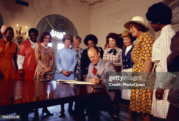 American politician US President Gerald Ford signs legislation declaring August 26th Women's Equality Day, Washington DC, August 22, 1974. Also...