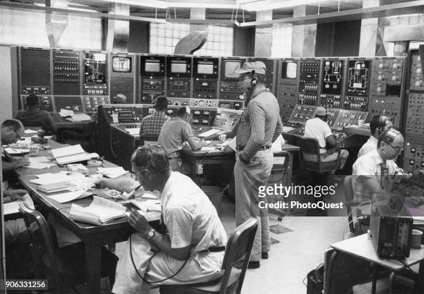 At Los Alamos Scientific Laboratory mission control, scientists at instrument panels fire a 'Kiwi' A3 nuclear rocket reactor, Los Alamos, New Mexico,...