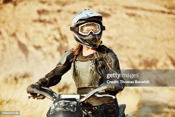 portrait of female dirt bike rider during desert ride - chest protector stock pictures, royalty-free photos & images