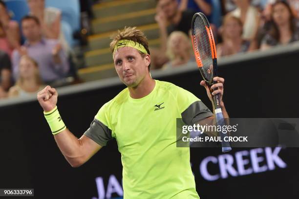 Tennys Sandgren of the US celebrates beating Switzerland's Stanislas Wawrinka in their men's singles second round match on day four of the Australian...