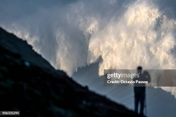 One man take photos of the waves and surfers during a surf session at Praia do Norte on January 18, 2018 in Nazare, Portugal.