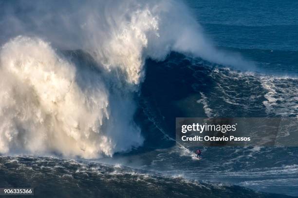 French big wave surfer Benjamin Sanchez, drops a wave during a surf session at Praia do Norte on January 18, 2018 in Nazare, Portugal.