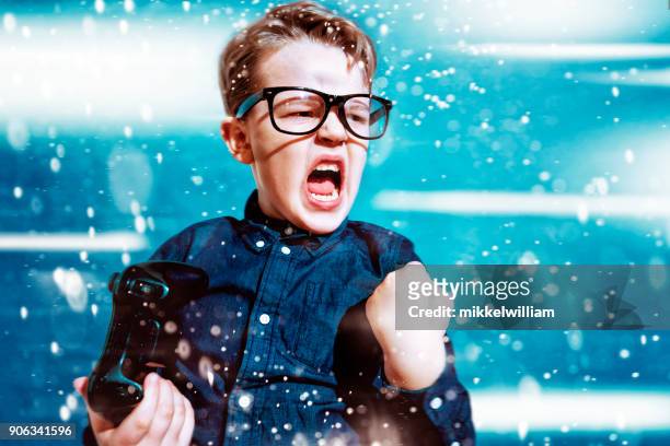 kid with game controller wins sport match and cheers - boys gaming stock pictures, royalty-free photos & images