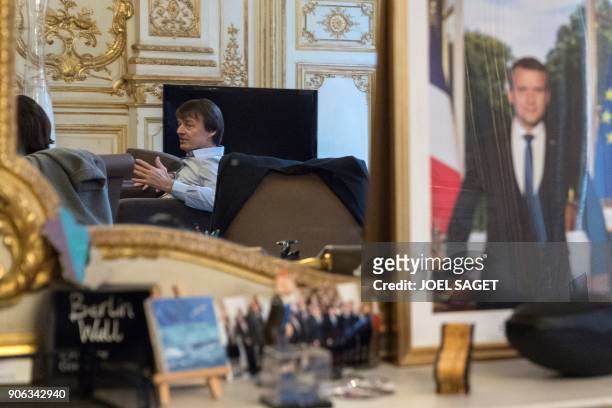 French Minister for the Ecological and Inclusive Transition Nicolas Hulot is pictured in a mirror at the Environment ministry in Paris on January 18,...