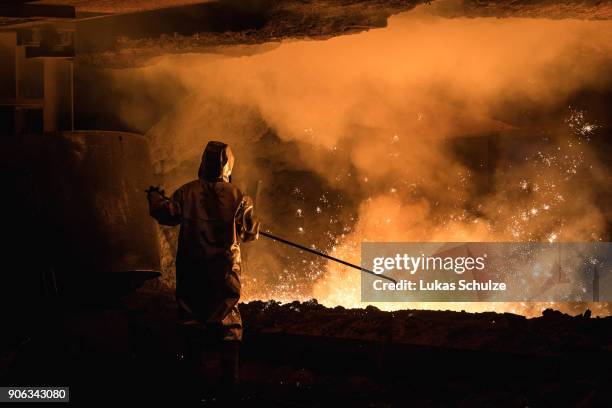 Worker oversees molten iron undergoing purification and alloying to become steel at the ThyssenKrupp steelworks on January 17, 2018 in Duisburg,...