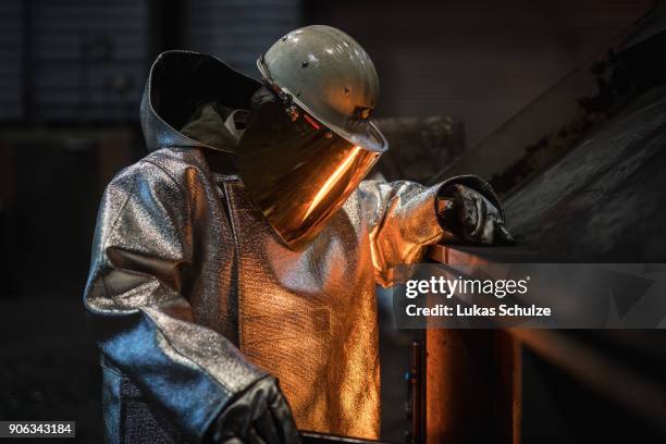 Worker oversees molten iron undergoing purification and alloying to become steel at the ThyssenKrupp steelworks on January 17, 2018 in Duisburg,...