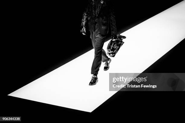 Model walks the runway at the Emporio Armani show during Milan Men's Fashion Week Fall/Winter 2018/19 on January 13, 2018 in Milan, Italy.