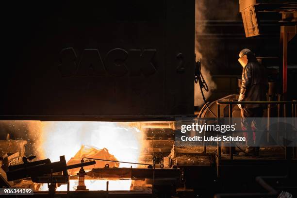 Worker oversees molten iron undergoing purification and alloying to become steel at the ThyssenKrupp steelworks on January 17, 2018 in Duisburg,...