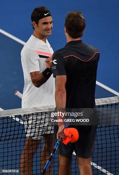 Switzerland's Roger Federer shakes hands as he celebrates after victory Germany's Jan-Lennard Struff during their men's singles second round match on...