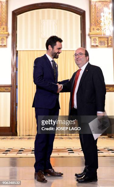 Newly elected Catalan parliament speaker Roger Torrent shakes hands with Catalan Socialist Party leader, Miquel Iceta prior to holding a meeting at...