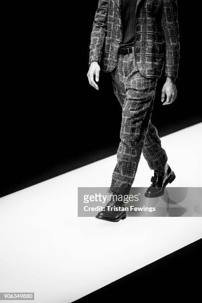Model walks the runway at the Giorgio Armani show during Milan Men's Fashion Week Fall/Winter 2018/19 on January 15, 2018 in Milan, Italy.