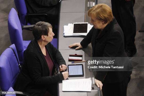 German environment ministry Barbara Hendricks chats with German Chancellor Angela Merkel at the plenary session of the Bundestag following a memorial...