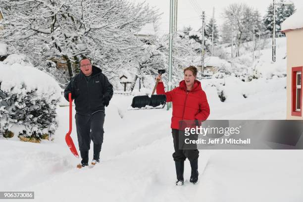 Villagers prepare to clear snow with shovels, following extensive snowfall during the last forty eight hours on January 18, 2018 in Leadhills,...