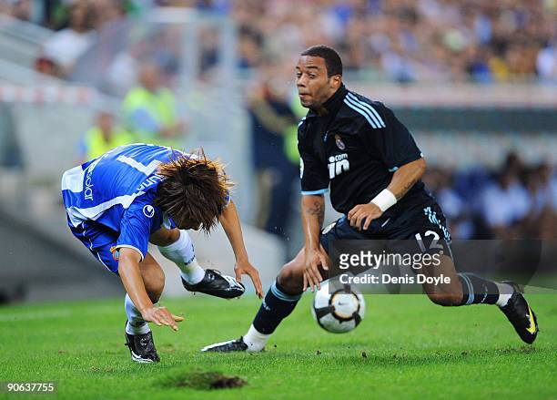 Shunsuke Nakamura of RCD Espanyol is tackled by Marcelo of Real Madrid during the La Liga match between Espanyol and Real Madrid at the Nuevo Estadio...