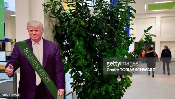 Cardboard depicting US President Donald Trump wearing a ribbon reading "flowers first" is is installed in a hall before the opening day of the...