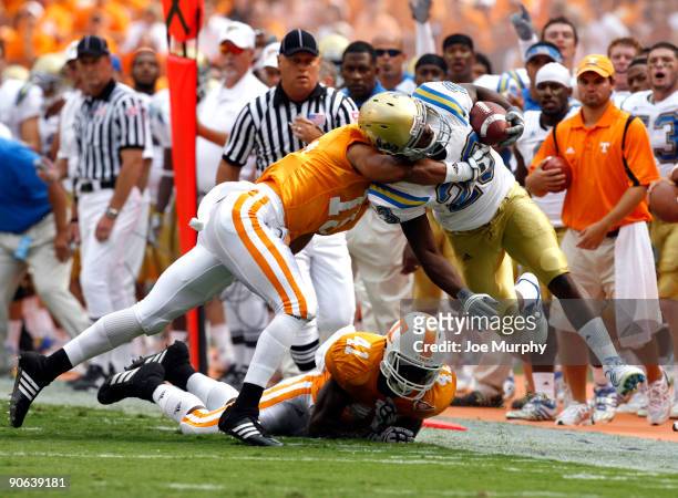 Jonathan Franklin of the UCLA Bruins is knocked out of bounds by Janzen Jackson of the Tennessee Volunteers on September 12, 2009 at Neyland Stadium...