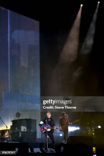 Chris Martin and Guy Berryman of Coldplay perform on stage at Old Trafford on September 12, 2009 in Manchester, England.