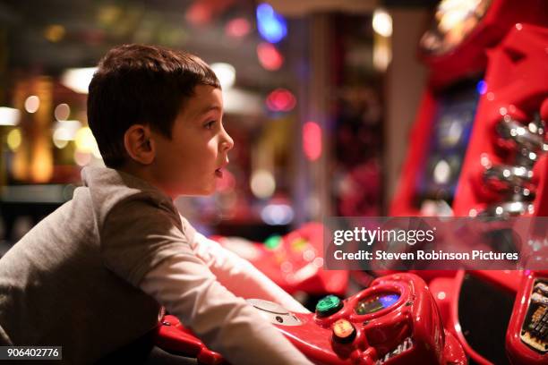 playing in the arcade - arcade stock pictures, royalty-free photos & images