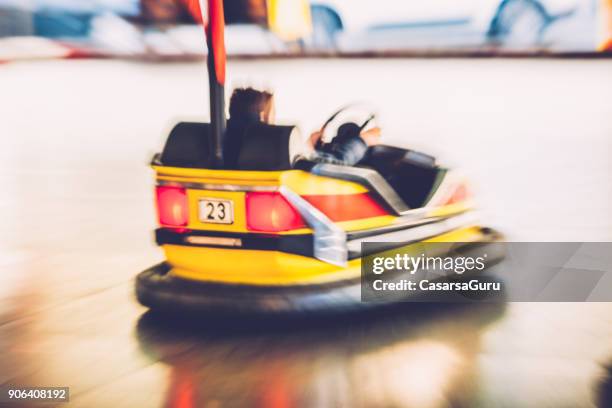 blurred motion of a boy driving a bumper car - motorized vehicle riding stock pictures, royalty-free photos & images