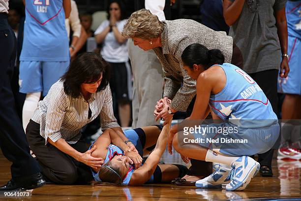Trainers attend to Shalee Lehning of the Atlanta Dream after injuring her shoulder against the Washington Mystics at the Verizon Center on September...