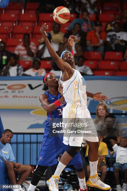Sylvia Fowles of the Chicago Sky jumps to grab a wild pass as Cheryl Ford of the Detroit Shock pushes from behind during the WNBA game on September...