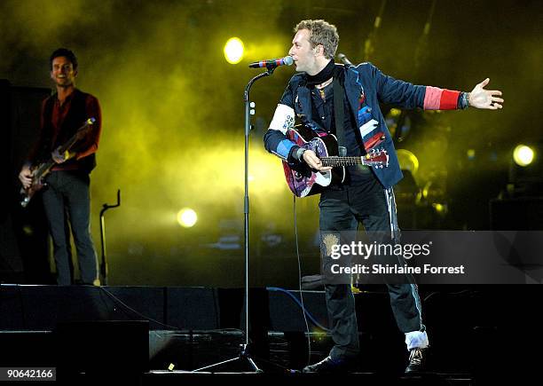Chris Martin and Guy Berryman of Coldplay perform at Lancahire County Cricket Club on September 12, 2009 in Manchester, England.
