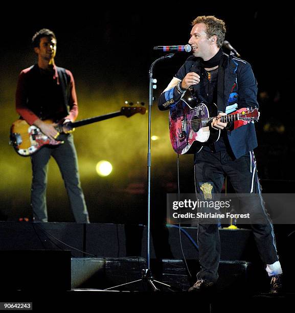 Chris Martin and Guy Berryman of Coldplay perform at Lancahire County Cricket Club on September 12, 2009 in Manchester, England.