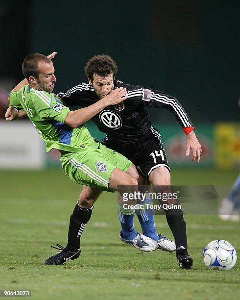 Ben Olsen of D.C. United battles for the ball with Peter Vagenas of Seattle Sounders FC during an MLS match at RFK Stadium on September 12, 2009 in...