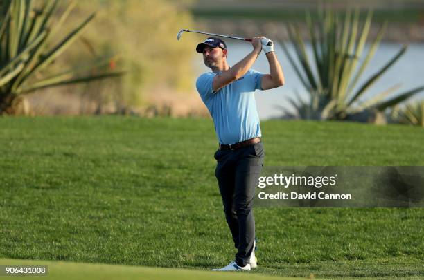 Paul Waring ofg England plays his second shot on the par 4, 17th hole during the first round of the 2018 Abu Dhabi HSBC Golf Championship at the Abu...