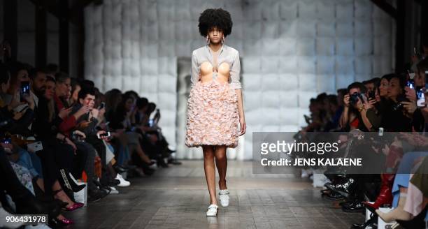 Model presents fashion of the label "Marina Hoermanseder" during the Fashion Week in Berlin on January 18, 2018. / AFP PHOTO / dpa / Jens Kalaene /...