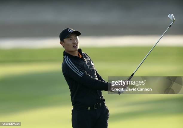 Haotong Li of China plays his second shot on the par 4, 17th hole during the first round of the 2018 Abu Dhabi HSBC Golf Championship at the Abu...