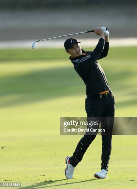 Haotong Li of China plays his second shot on the par 4, 17th hole during the first round of the 2018 Abu Dhabi HSBC Golf Championship at the Abu...