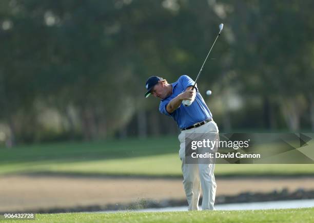 Ernie Els of South Africa plays his second shot on the par 4, 17th hole during the first round of the 2018 Abu Dhabi HSBC Golf Championship at the...