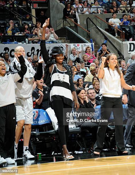 Sophia Young, Becky Hammon, Ann Wauters and Edwige Lawson-Wade of the San Antonio Silver Stars cheer on their team from the bench during the game...