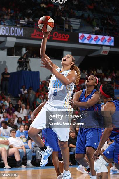 Mistie Bass of the Chicago Sky shoots past Kara Braxton of the Detroit Shock during the WNBA game on September 12, 2009 at the UIC Pavilion in...