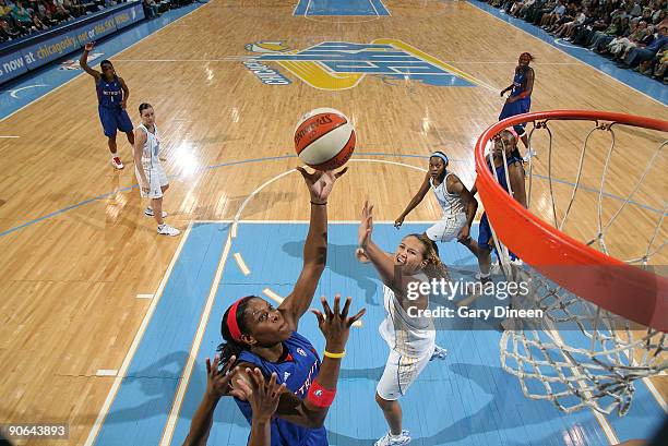 Taj McWilliams of the Detroit Shock puts the ball up past Mistie Bass of the Chicago Sky during the WNBA game on September 12, 2009 at the UIC...