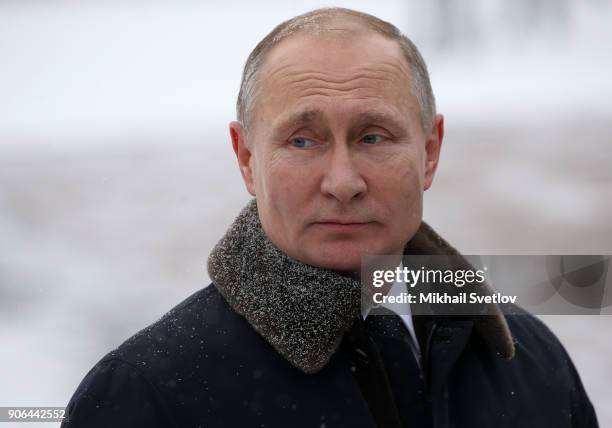 Russian President Vladimir Putin lays flowers on a monuments as he commemorates the 75th anniversary of the end of the Siege of Leningrad at...