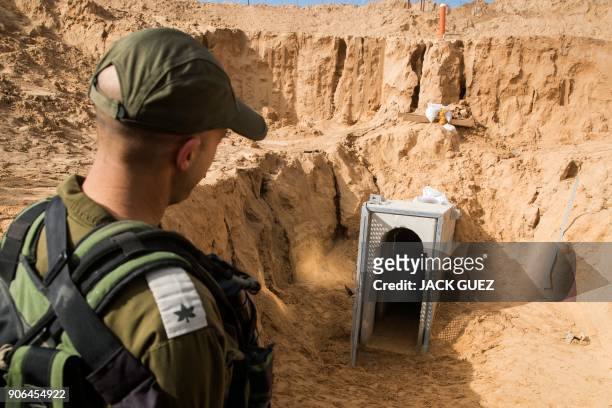 Picture taken on January 18, 2018 from the Israeli side of the border with the Gaza Strip shows a Israeli army officer walking near the entrance of a...