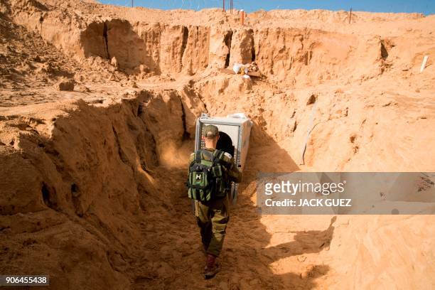 Picture taken on January 18, 2018 from the Israeli side of the border with the Gaza Strip shows a Israeli army officer walking near the entrance of a...