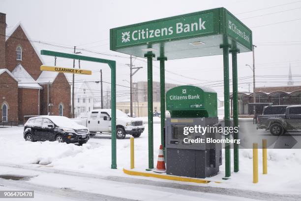 Snow falls in front of a drive-through automatic teller machine outside a Citizens Financial Group Inc. Bank branch in downtown Portsmouth, Ohio,...