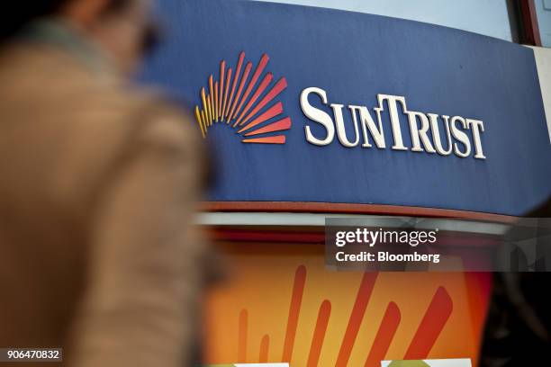 SunTrust Banks Inc. Signage is displayed outside an automatic teller machine in Washington, D.C., U.S., on Thursday, Jan. 11, 2018. SunTrust Banks...