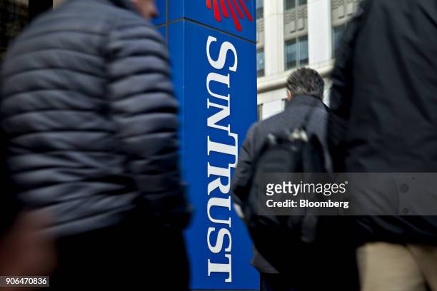Pedestrians pass in front of a SunTrust Banks Inc. Branch in Washington, D.C., U.S., on Thursday, Jan. 11, 2018. SunTrust Banks Inc. Is scheduled to...