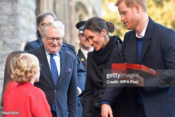 Harry Smith and Megan Taylor, both from Marlborough Primary School, present a wedding gift to Prince Harry and his fiancee Meghan Markle during their...