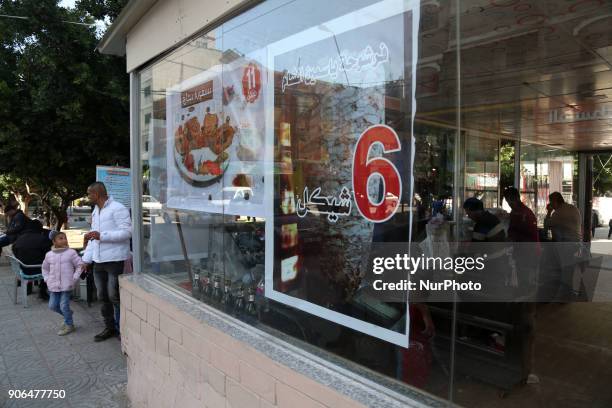 In the picture, a resturant make offers at its meats and discount for his customers because the encomic conditions are so bad.Gazans are strapped for...