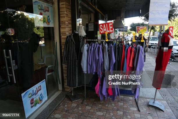 In the picture, the shop make offers and discounts on its goods .Gazans are strapped for cash and markets are suffering from an unprecedented...